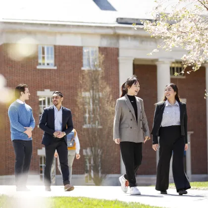 Students walking and chatting outside on campus