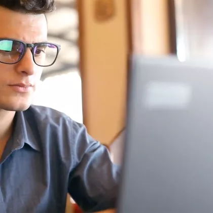 A student works on something on their laptop.